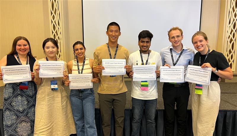 Carmen poses with a group of ADPs, all holding certificates.