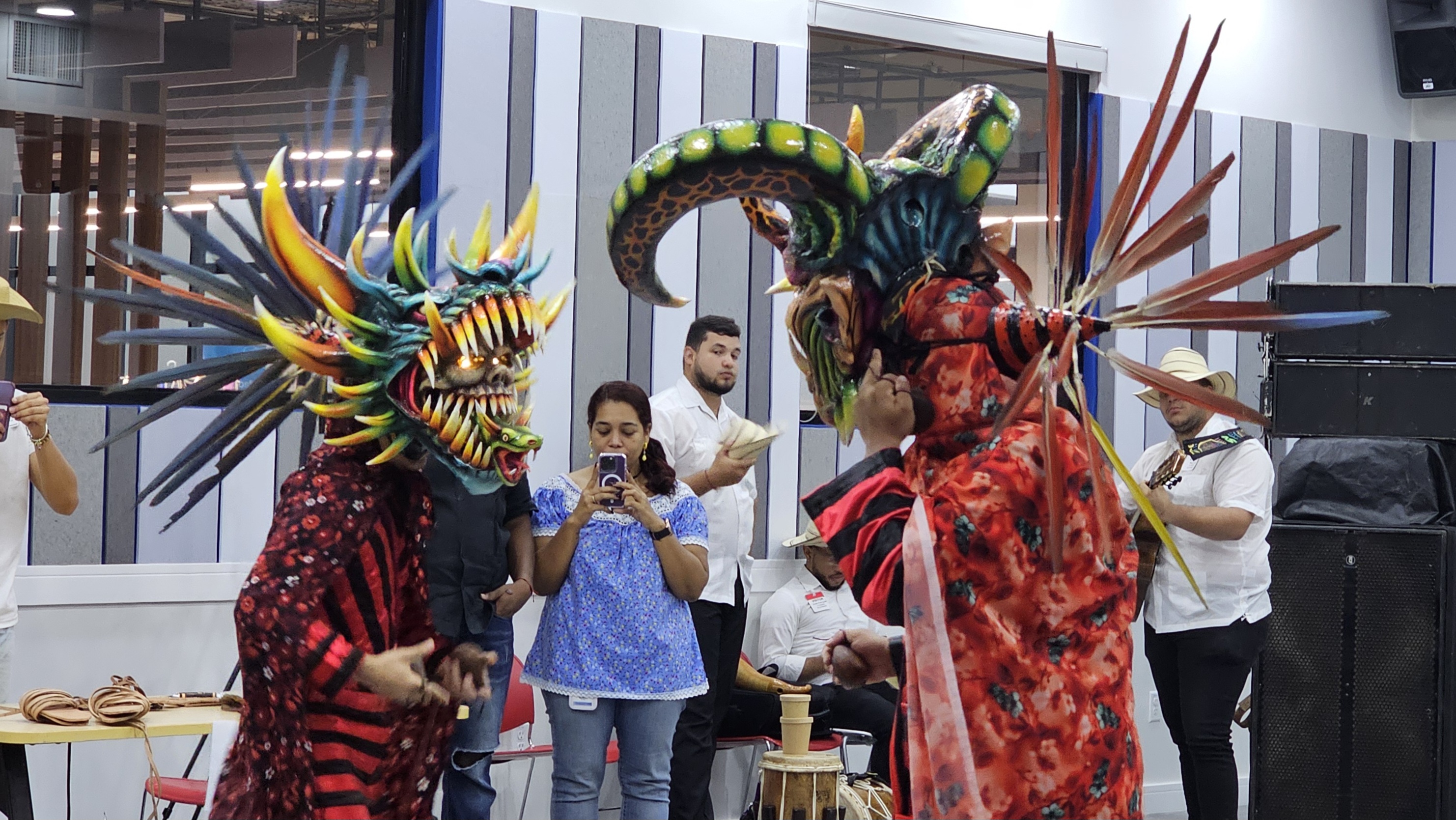 Dancers with large, colorful masks