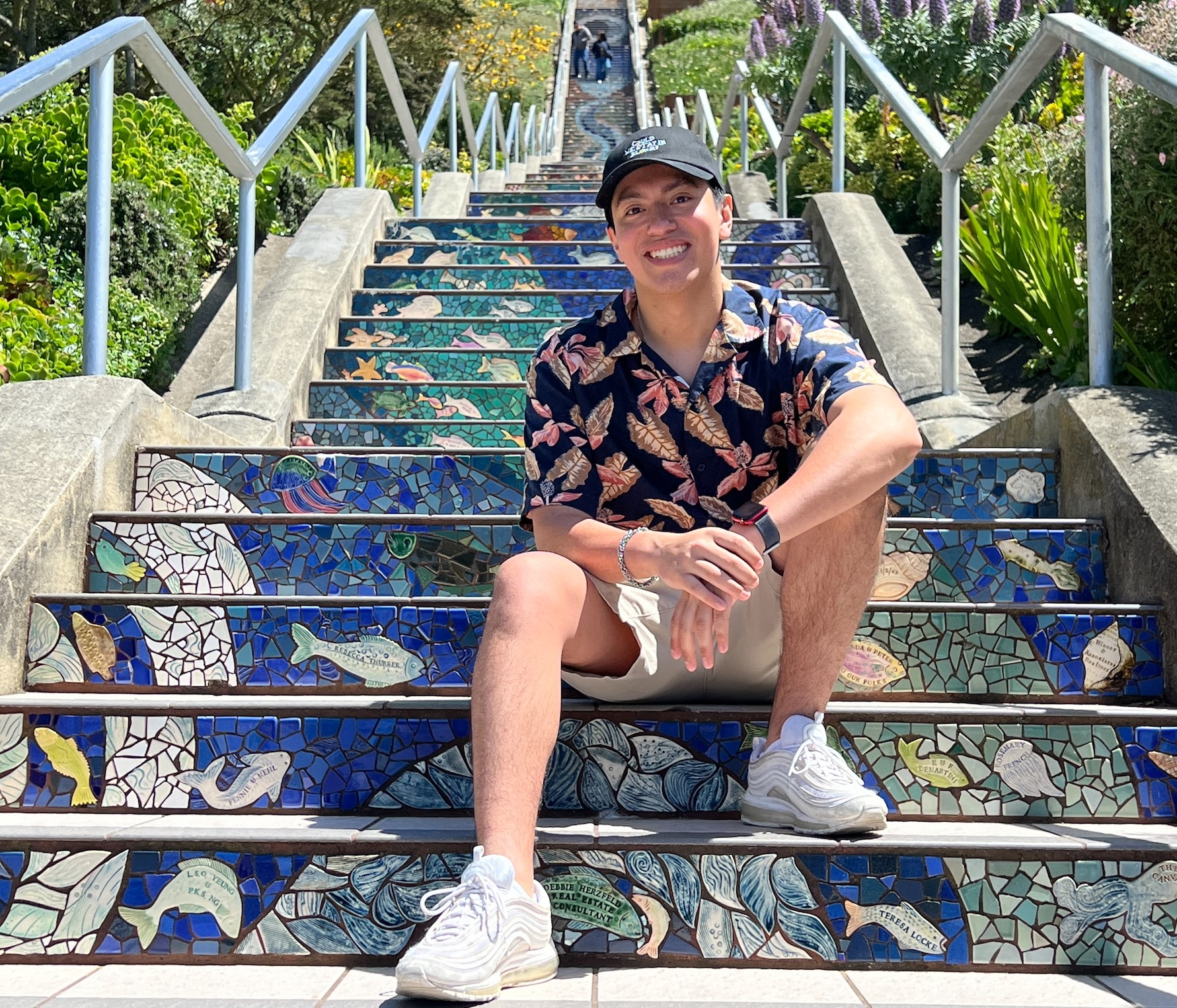 Eliel poses on stairs that are designed with an underwater scene.