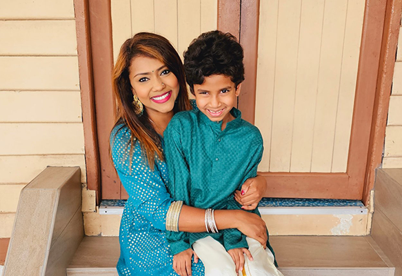 Shamizah smiles with her young son.