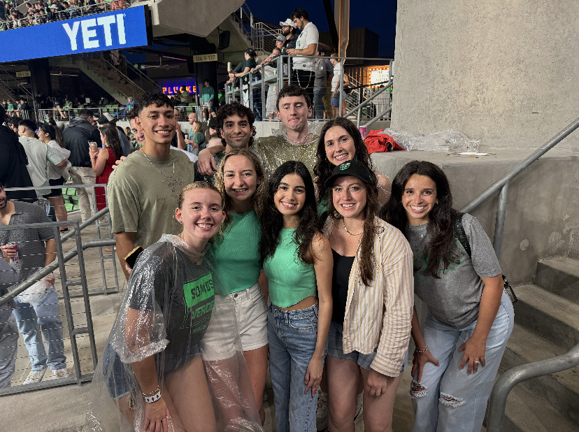 John at an Austin FC soccer game with a group of interns.