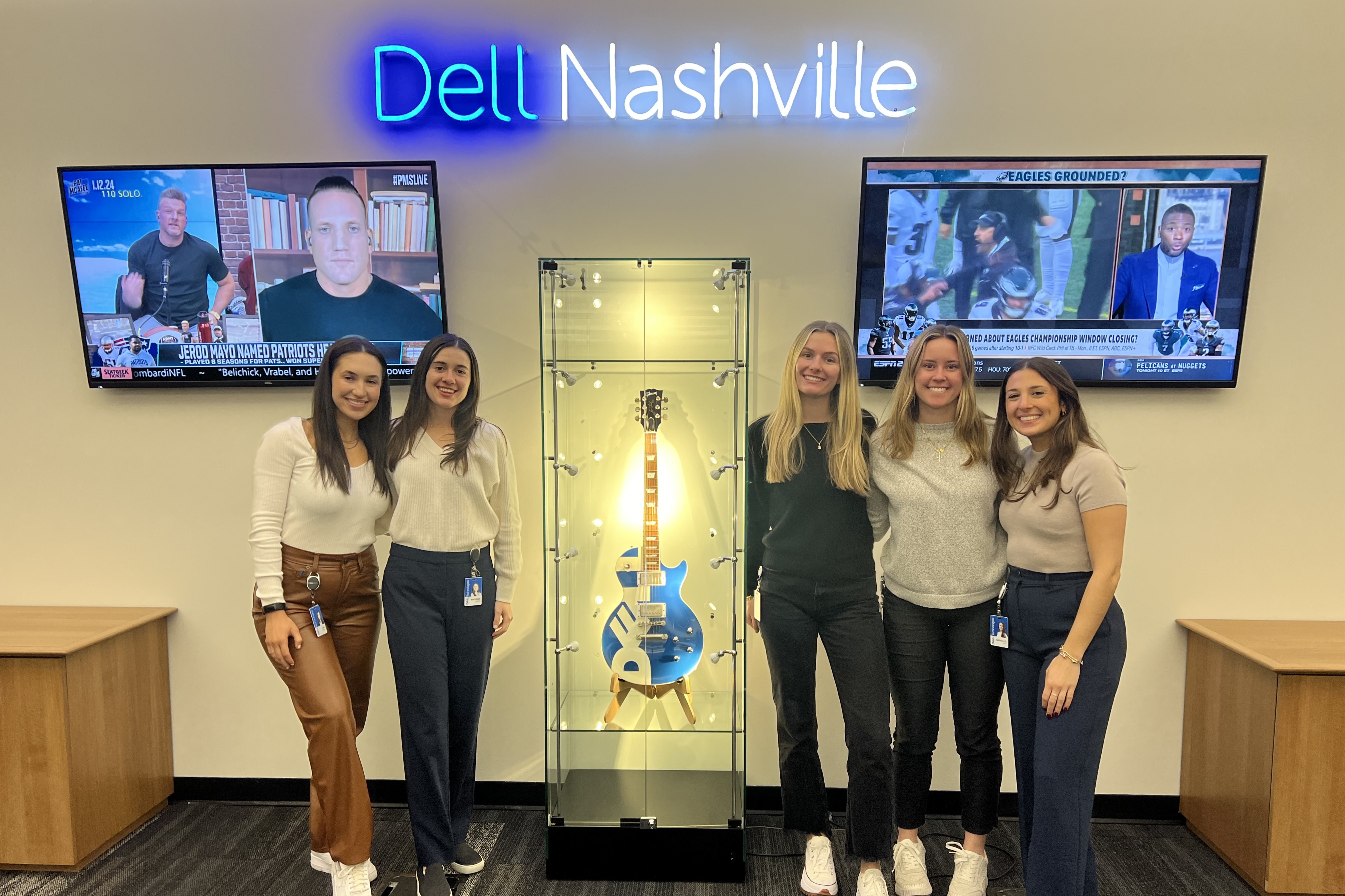 Madison and four other women pose in front of a Dell Nashville sign.