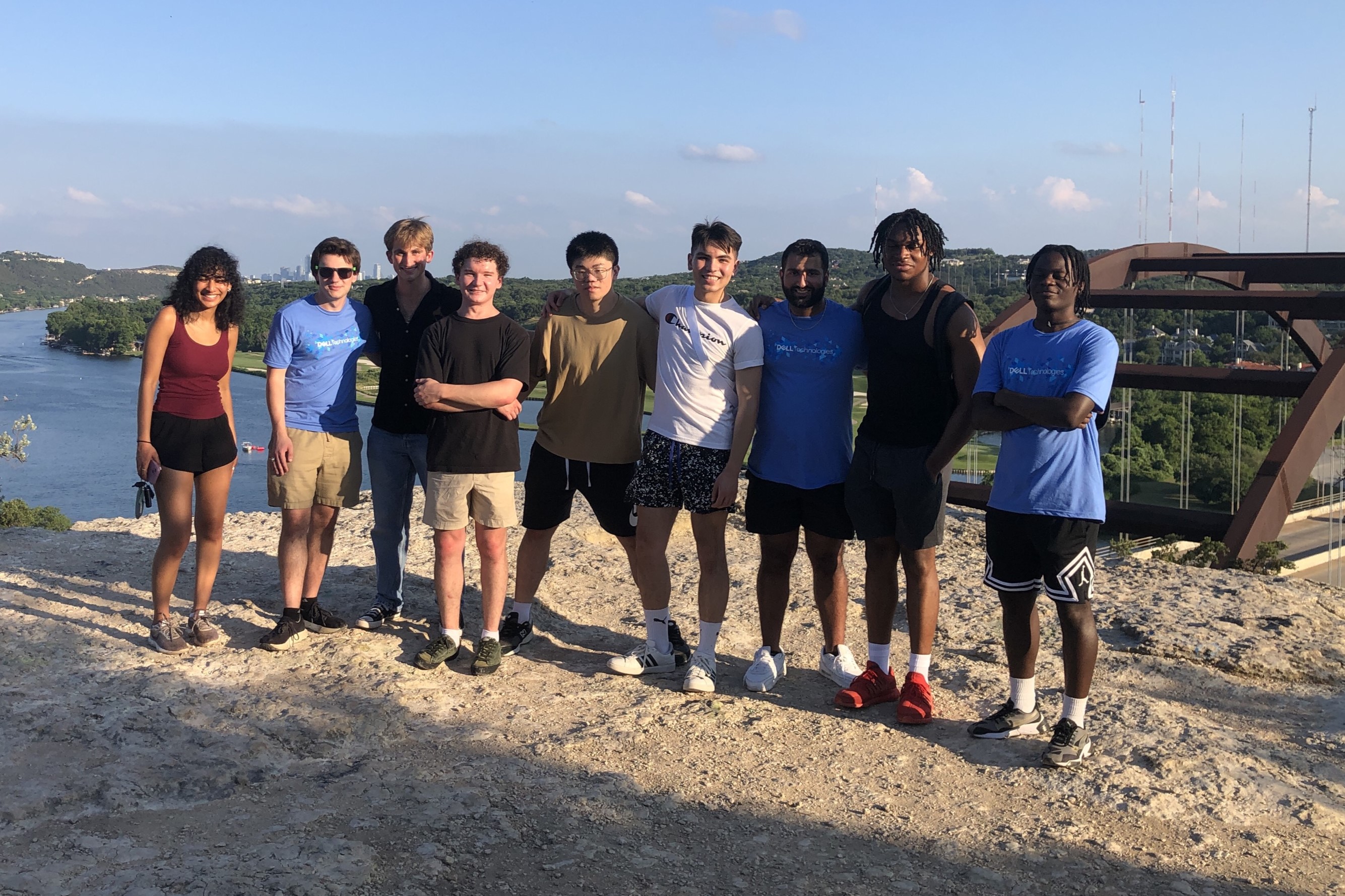 Matthew poses with a group of people at an overlook.