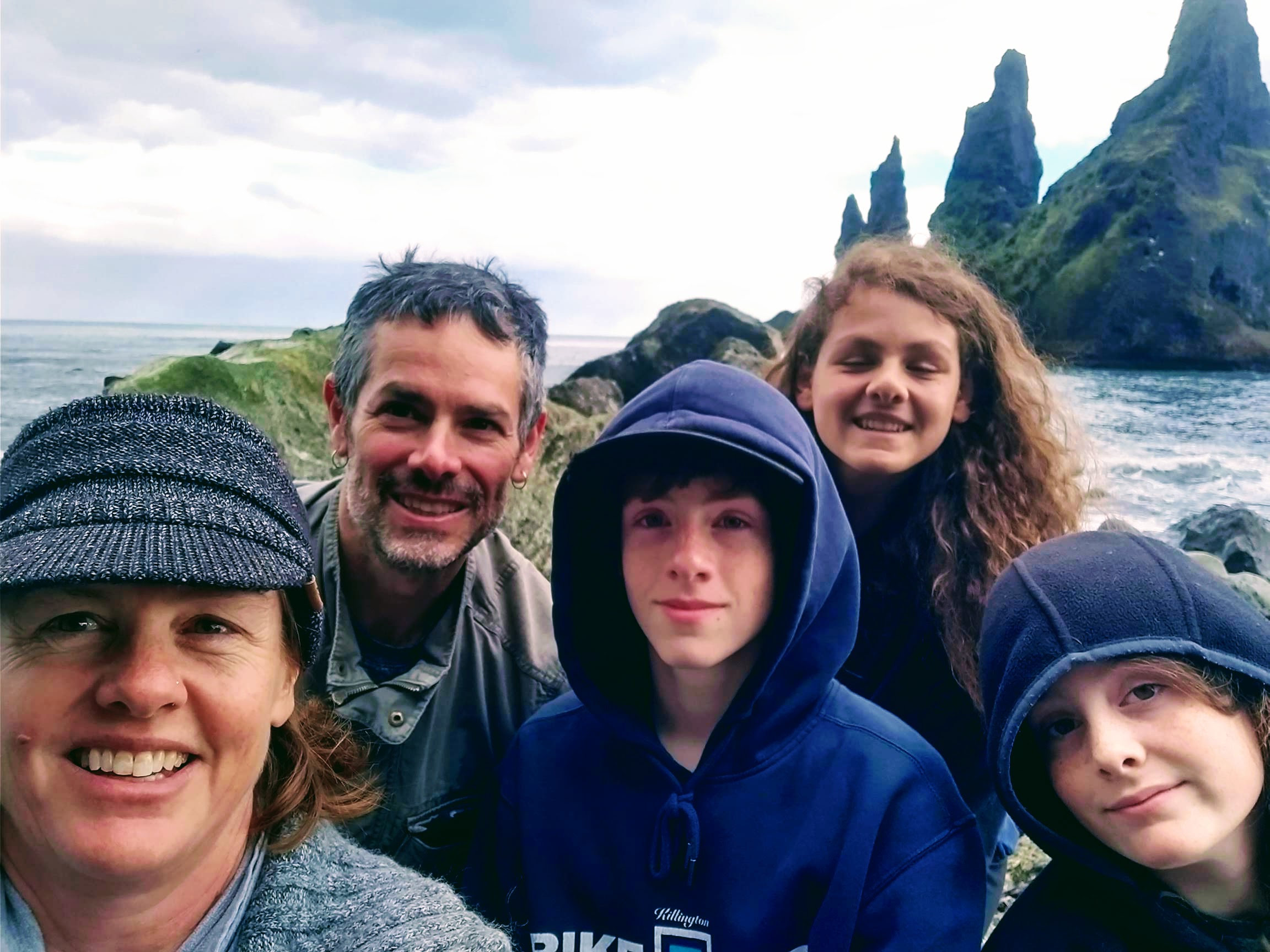 Michelle poses with her husband and three sons.