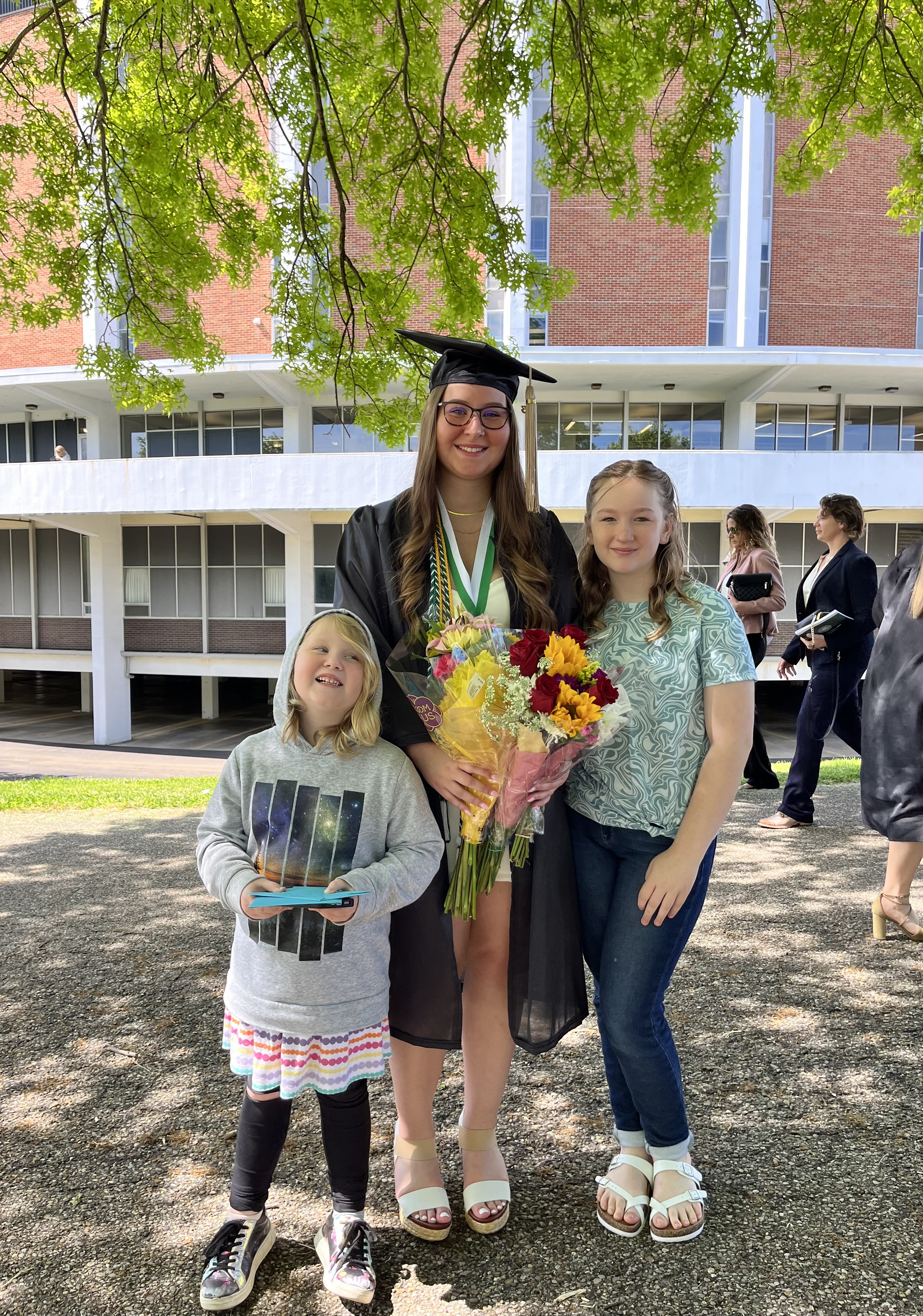 Nova and her two sisters at her college graduation.