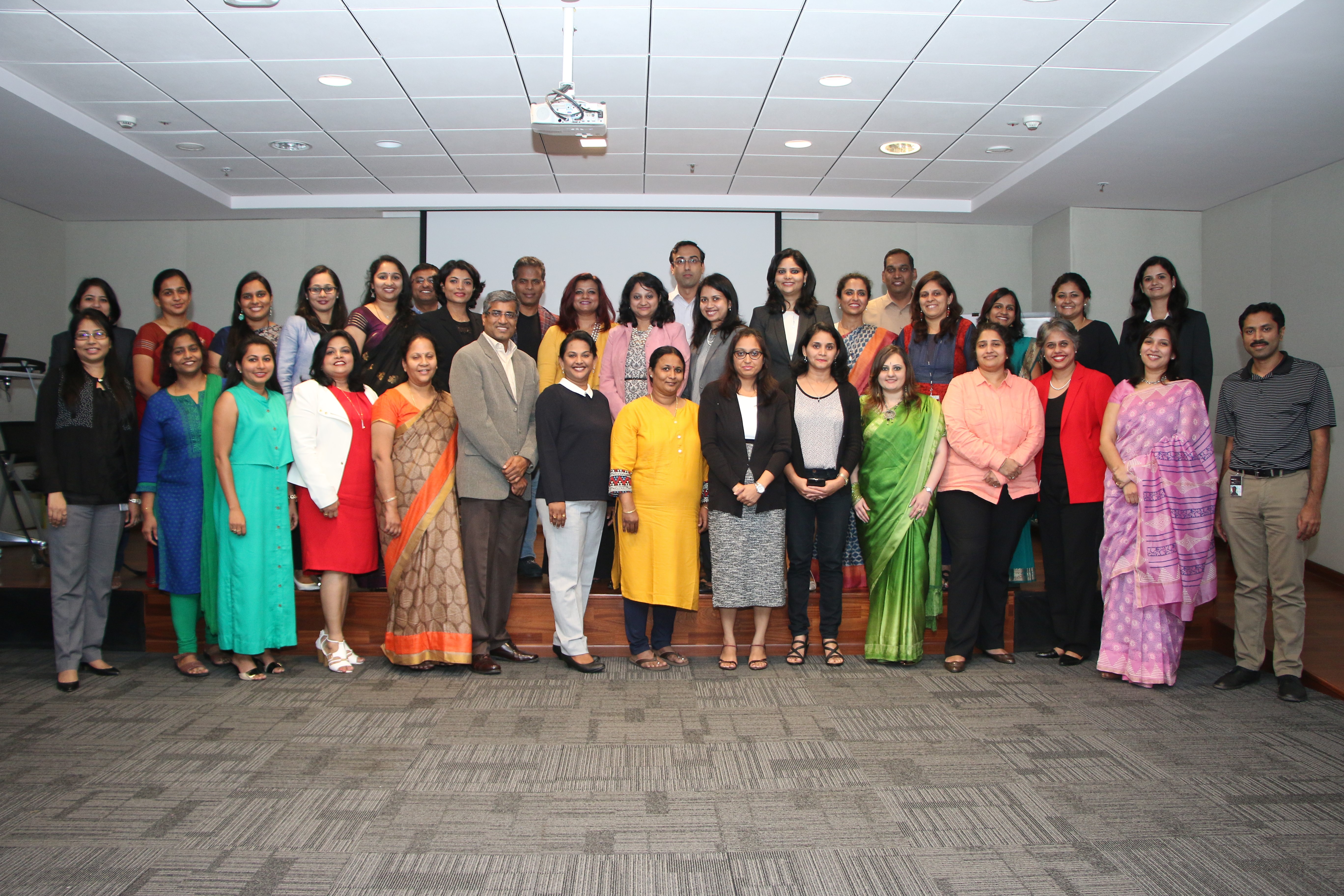 Renu poses with a group of people.