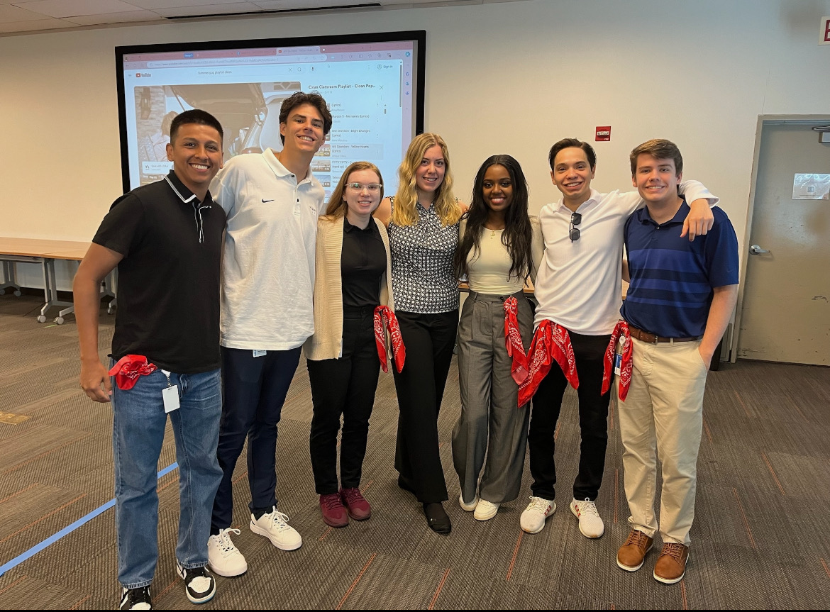 Sebastian poses with a group of interns during an activity.