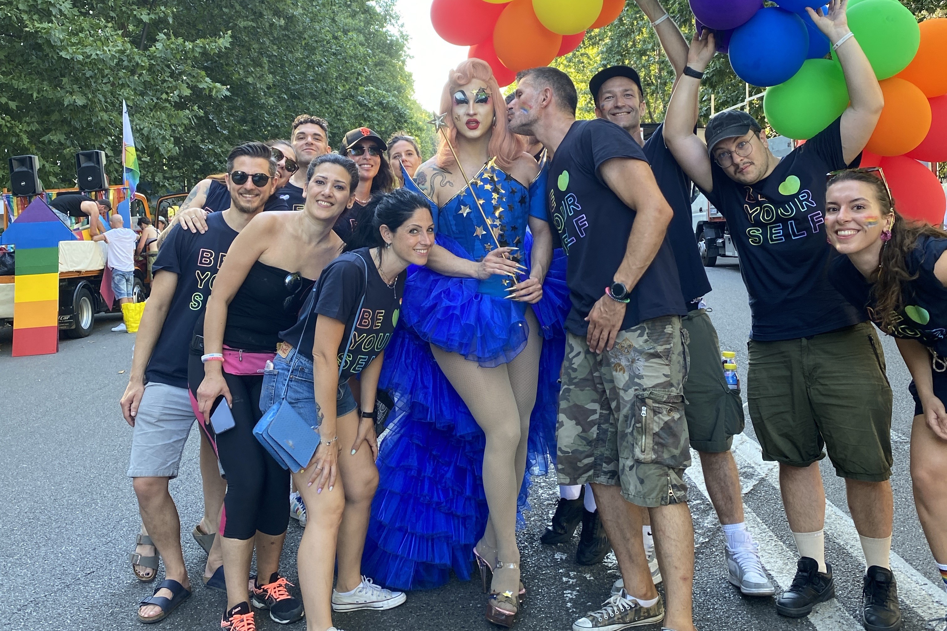 Stevo poses with a group of people at a Pride parade.