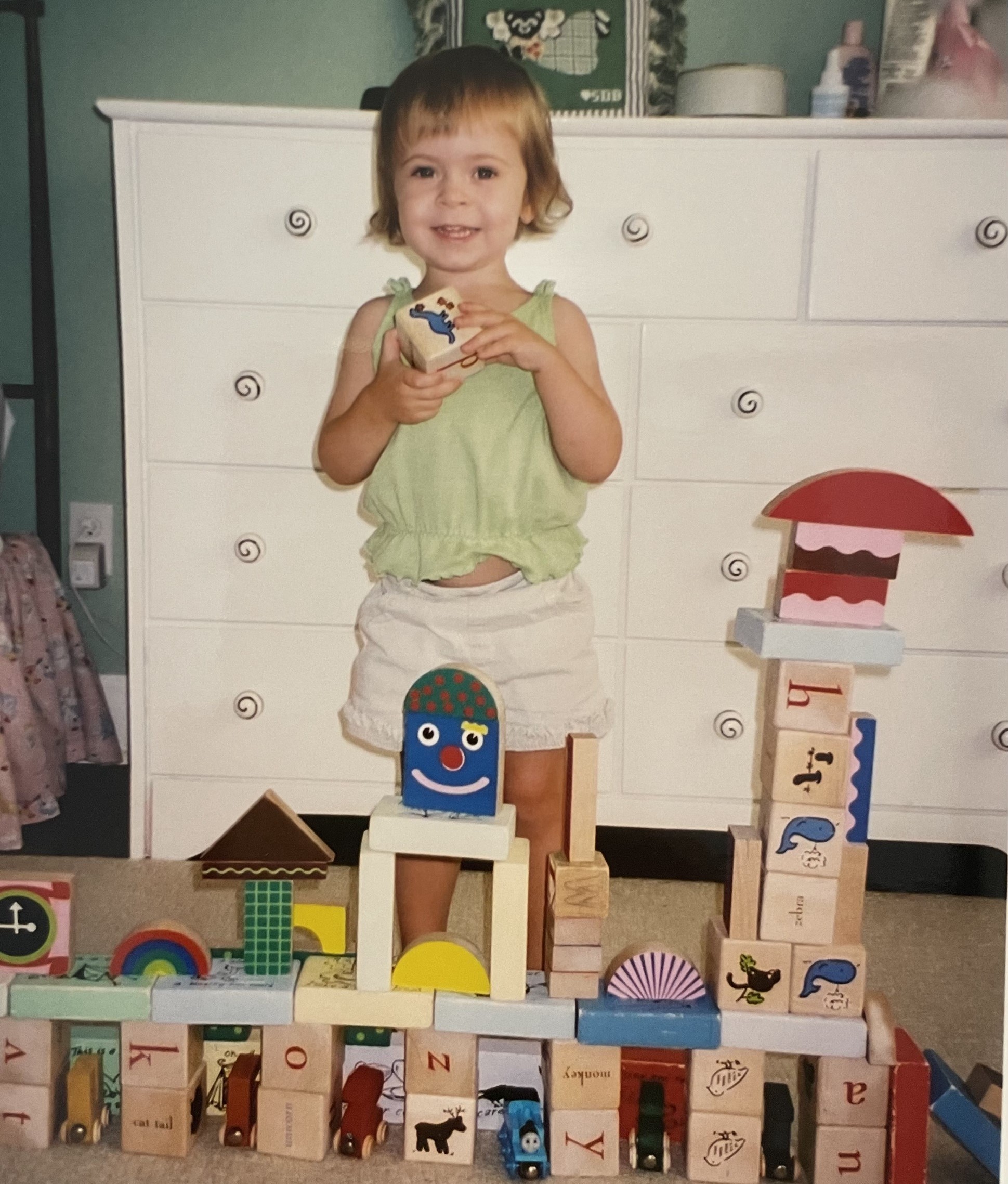 Childhood picture of Susie playing with toy blocks