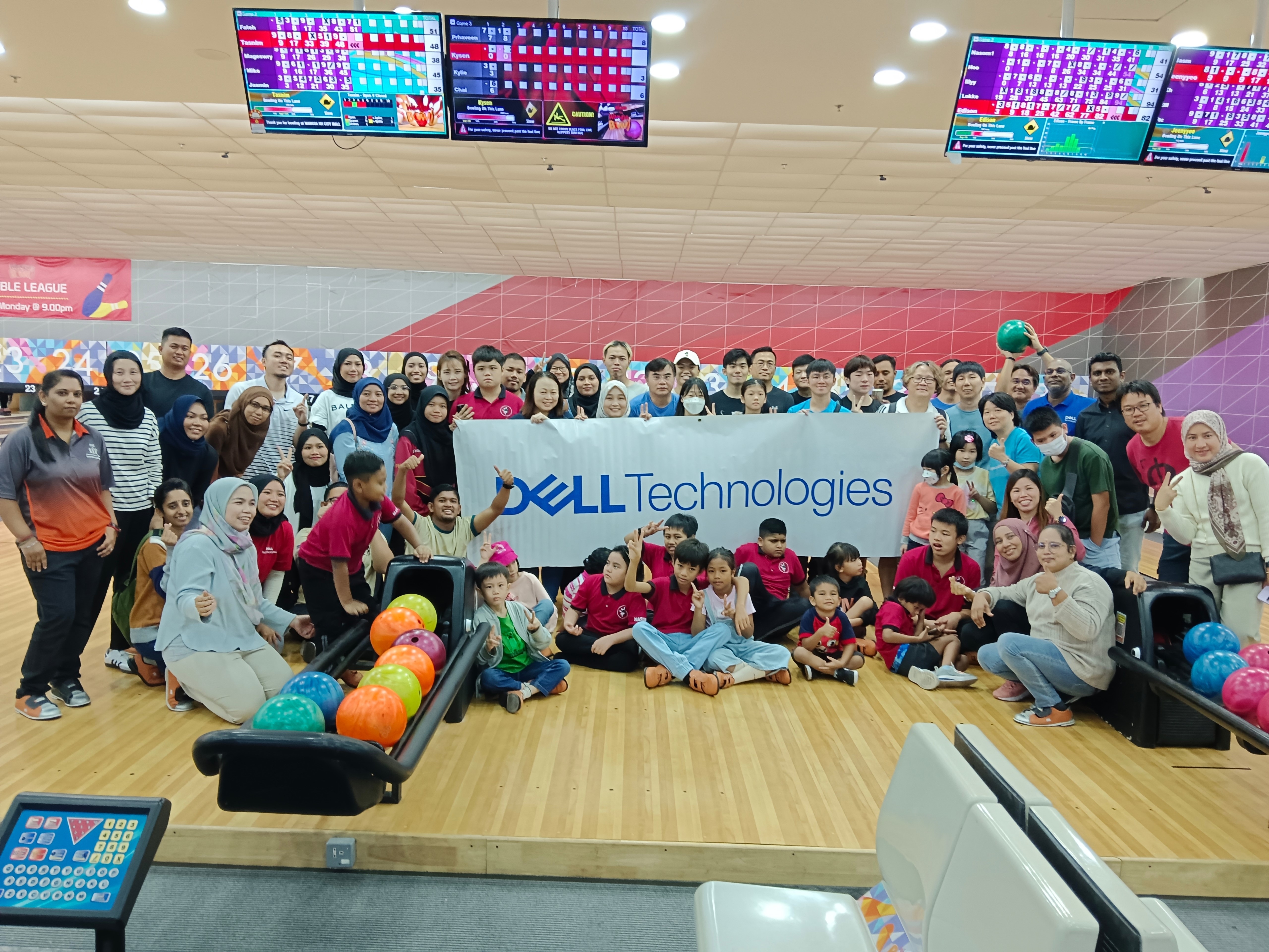 Suthagaran in a group photo at a bowling alley