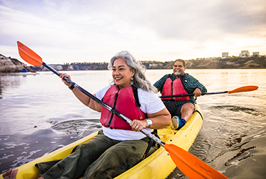 Retirement-age couple, paddling in a kayak