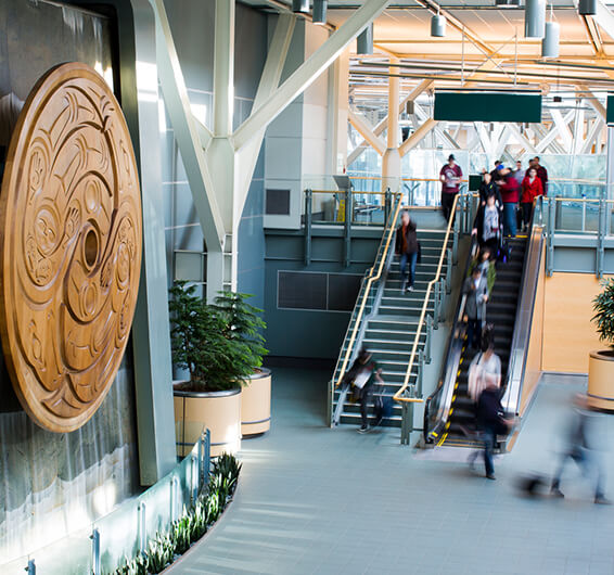 People on stairs in an airport terminal