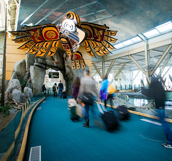 People walking on a walkway with luggage