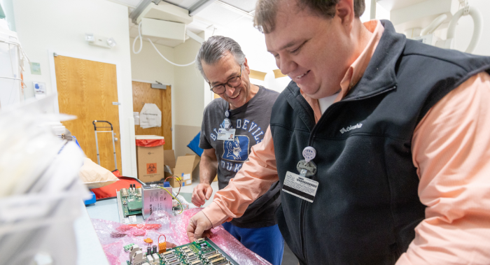Two team members working together on circuitry
