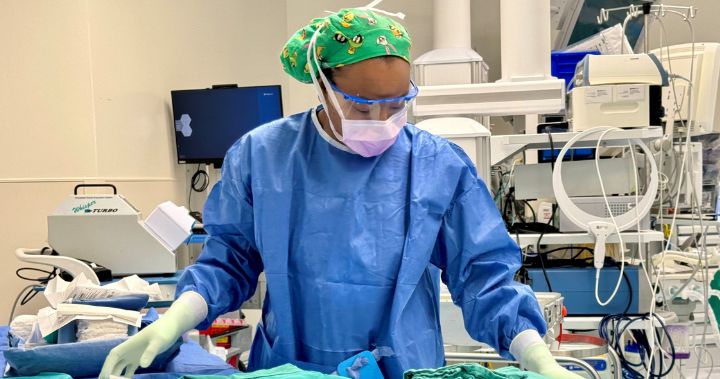 Kee is in full scrubs placing instruments in an operating room.