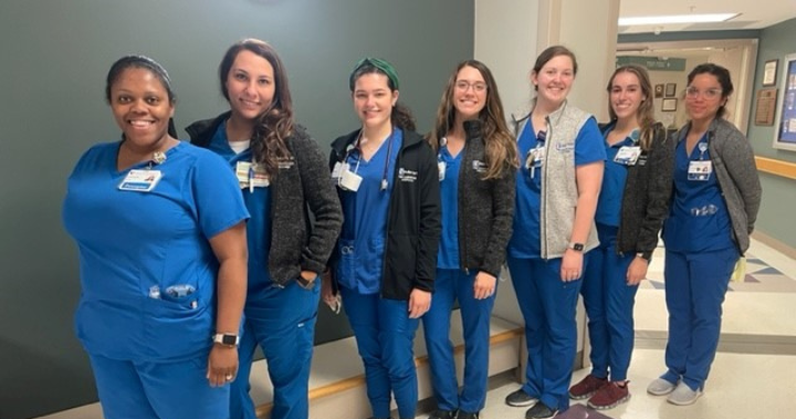 seven nursing team members smiling side by side