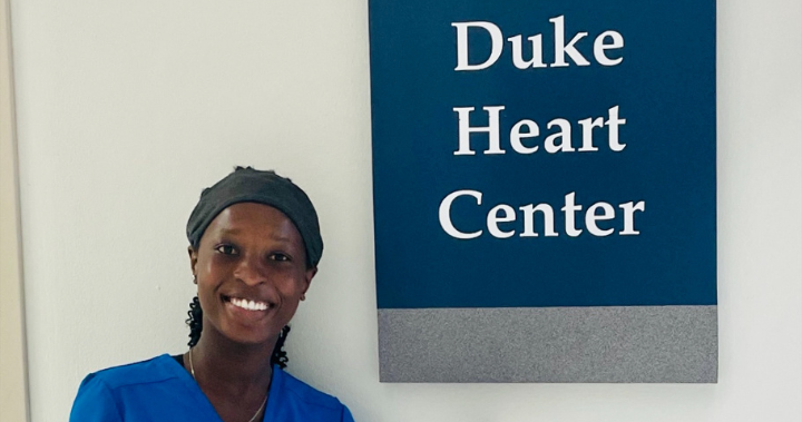 image of sarah quaye standing in front of duke heart center sign