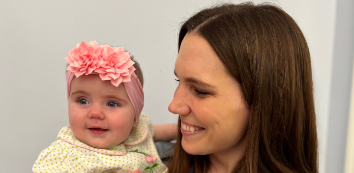 Shelby smiles at her infant daughter.