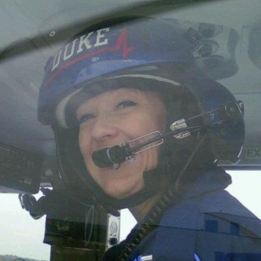 Kelly Cheek in helicopter with gear.