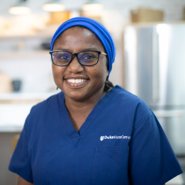 Marcene smiling in duke blue scrubs.