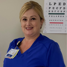 Amber smiles in blue scrubs.