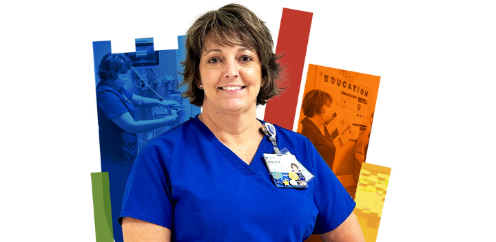 Deanna smiling in blue scrubs with a colorful Duke shield in the background.