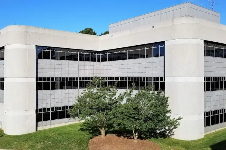 large office building with trees in front