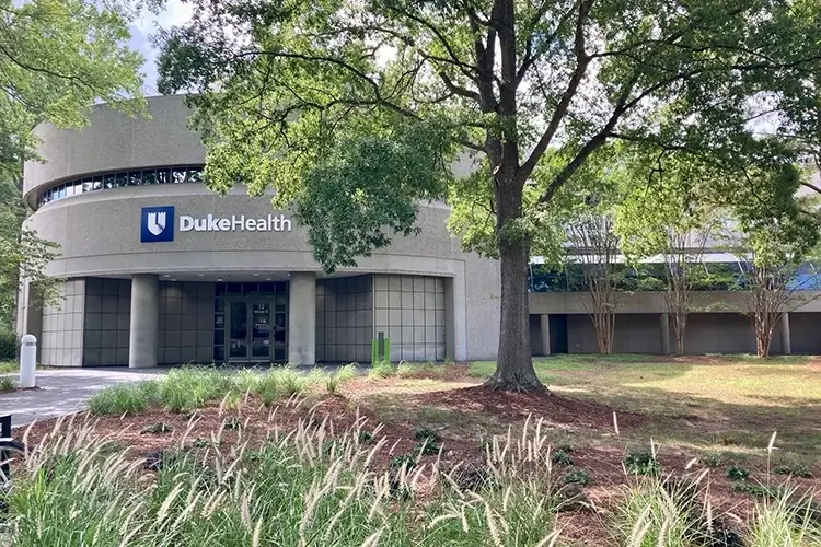 medical building surrounded by trees, with the Duke Health logo above the entrance