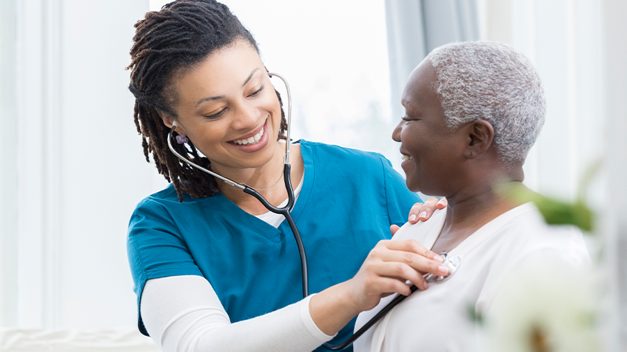 clinician using a stethoscope on a patient