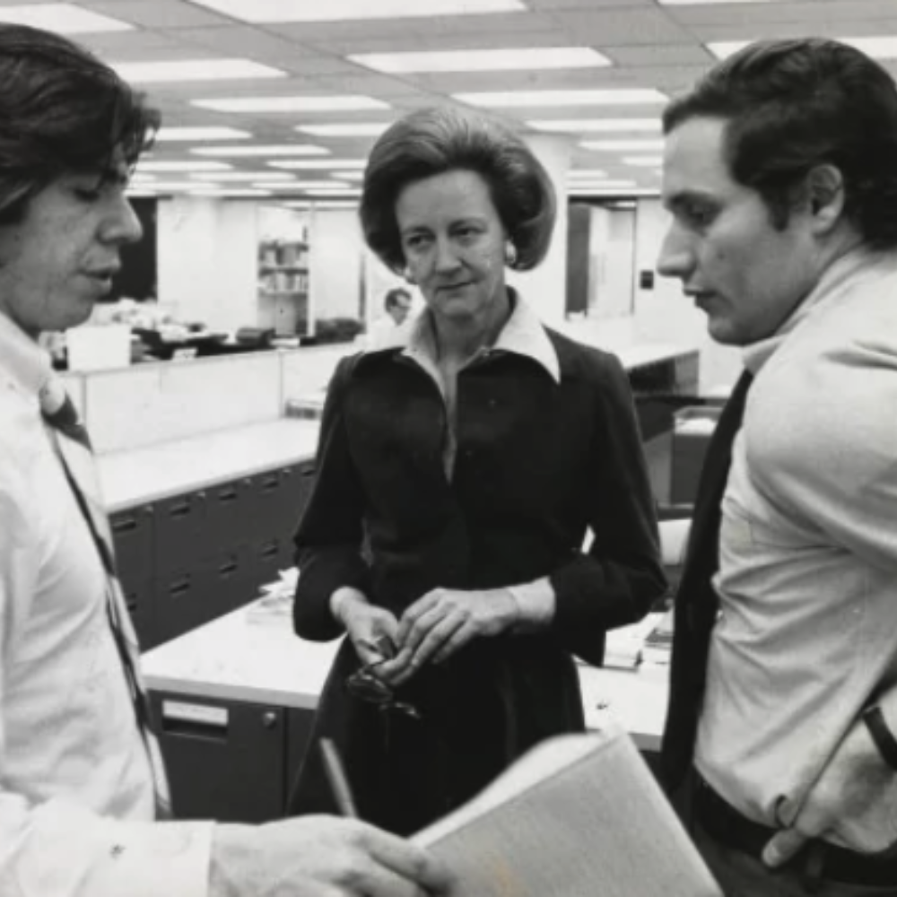 Katherine Graham standing with colleagues