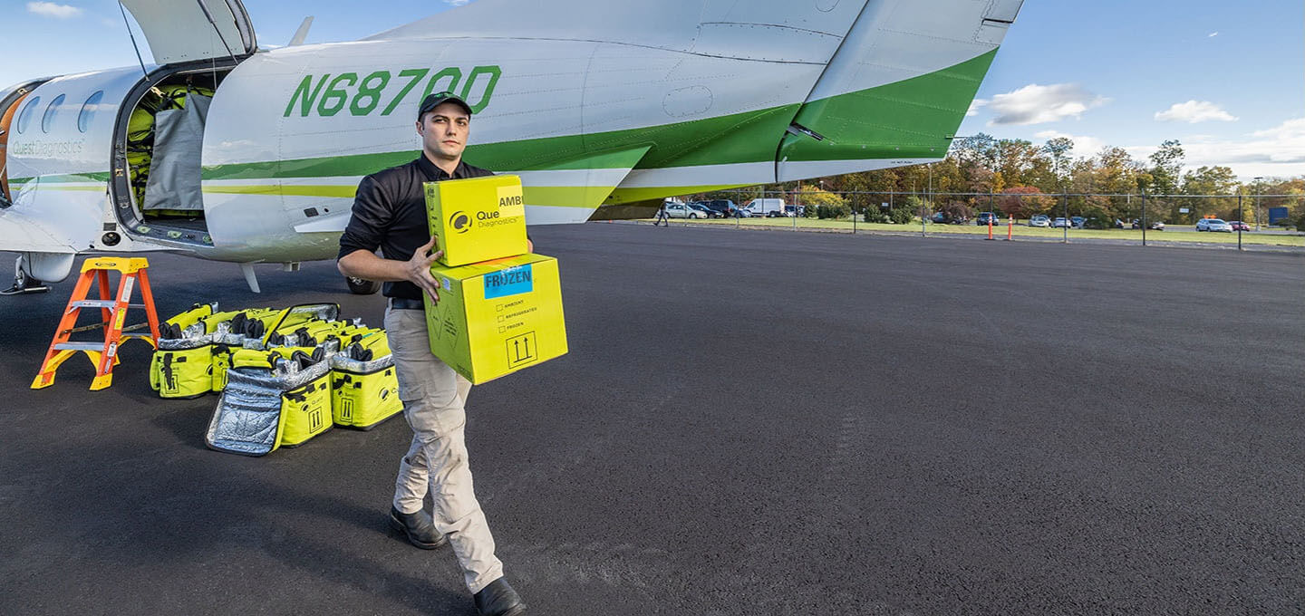 Employee carrying packages from plane
