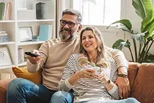 Two people sitting on a couch relaxing
