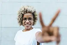 woman holding up a peace sign
