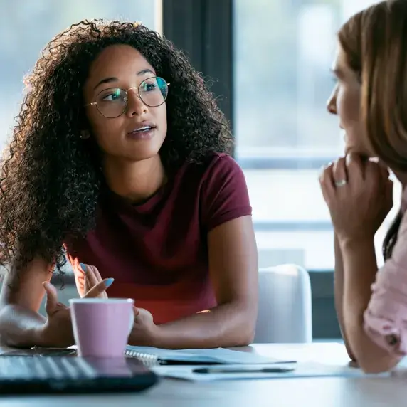 Two people talking to each other in a meeting