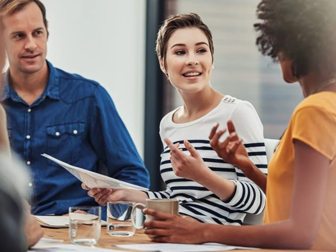 Group of people talking at a conference table