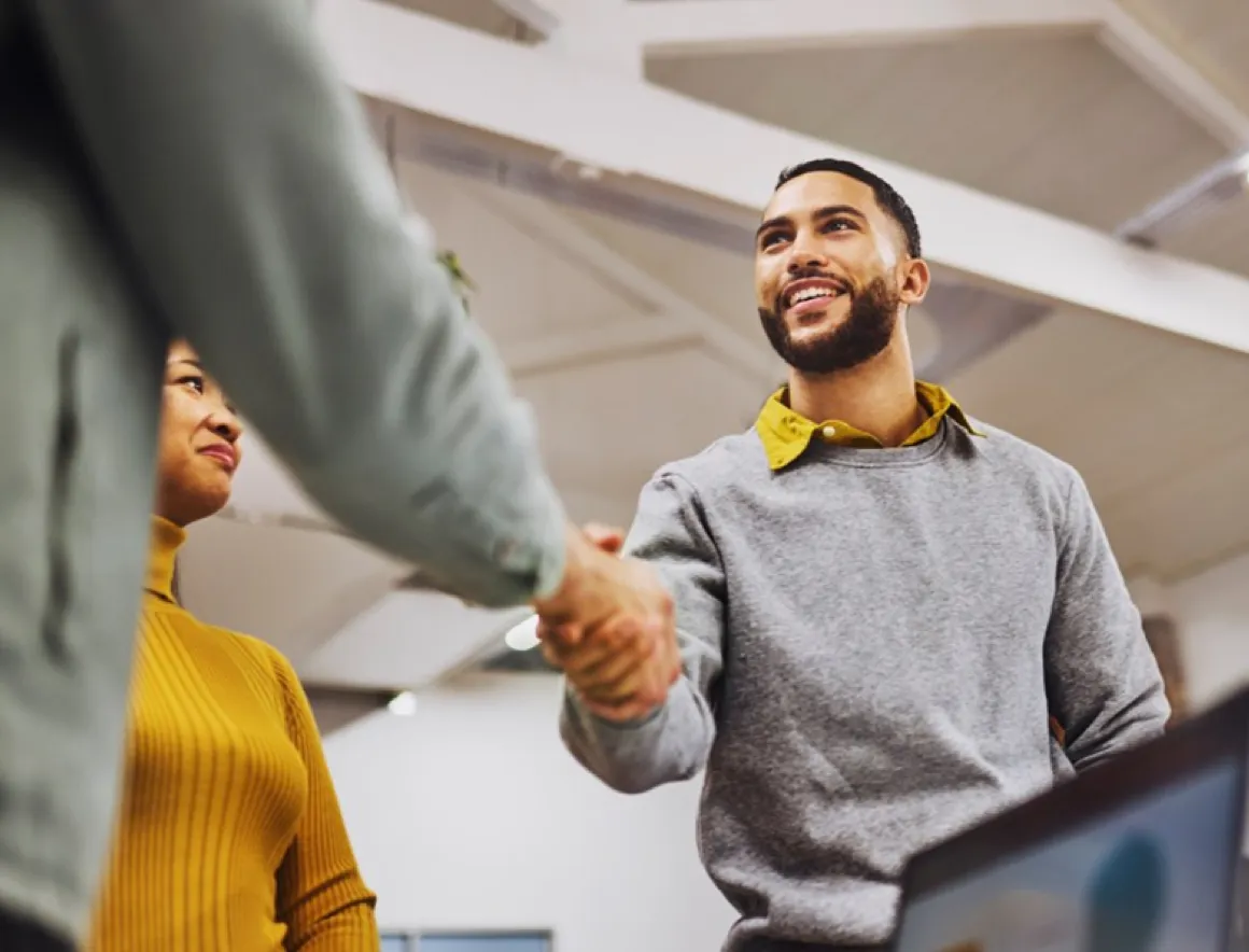Man smiling and greeting people