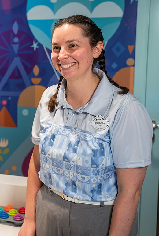 Brenna at the nursery, wearing her uniform and smiling