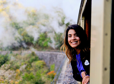 Employee - Woman leaning out of doorway and smiling