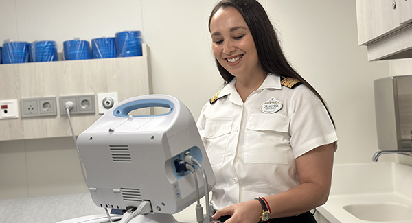 Female nurse talking to sitting female patient