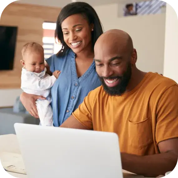 African American Family With Baby Using Laptop