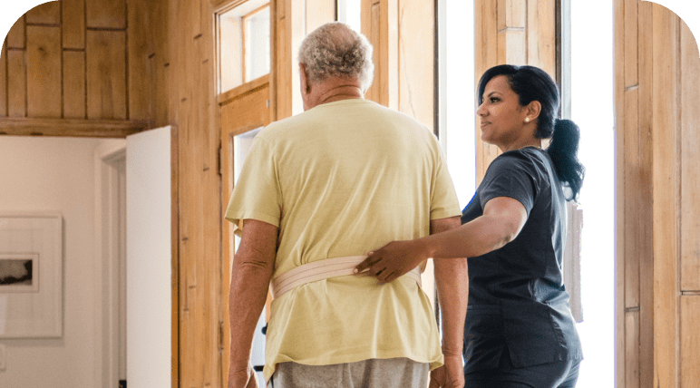 A nurse helping a patient walk