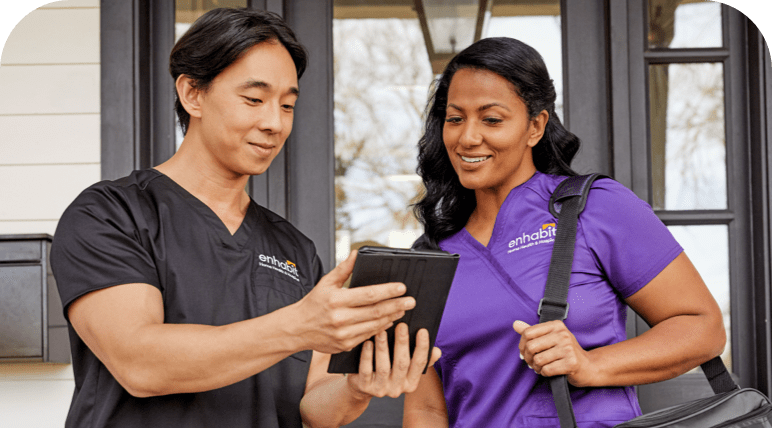 Two nurses staring at a tablet