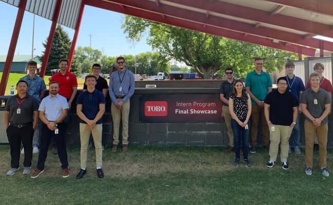Group of Interns in front of a sign: Toro Intern Program Final Showcase