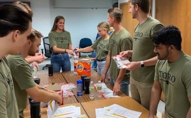 Group of Interns packaging donation supplies