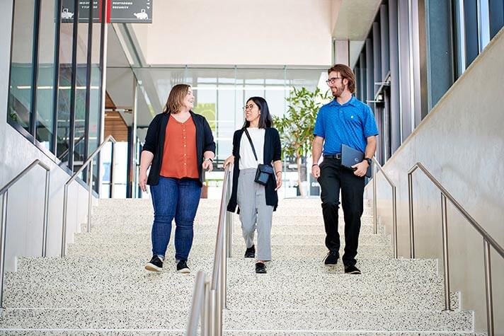 Employees standing around a computer