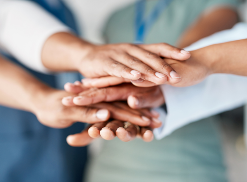 image of stacked human hands