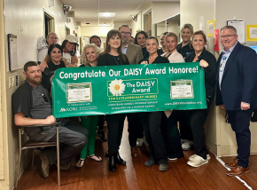 group photo of Havasu Regional Medical Center staff with DAISY Award banner