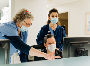 three medical staff members at workstation