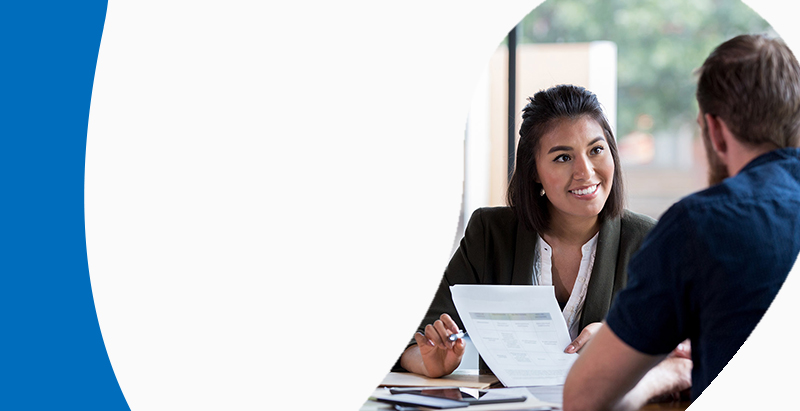 Woman at desk speaking to client