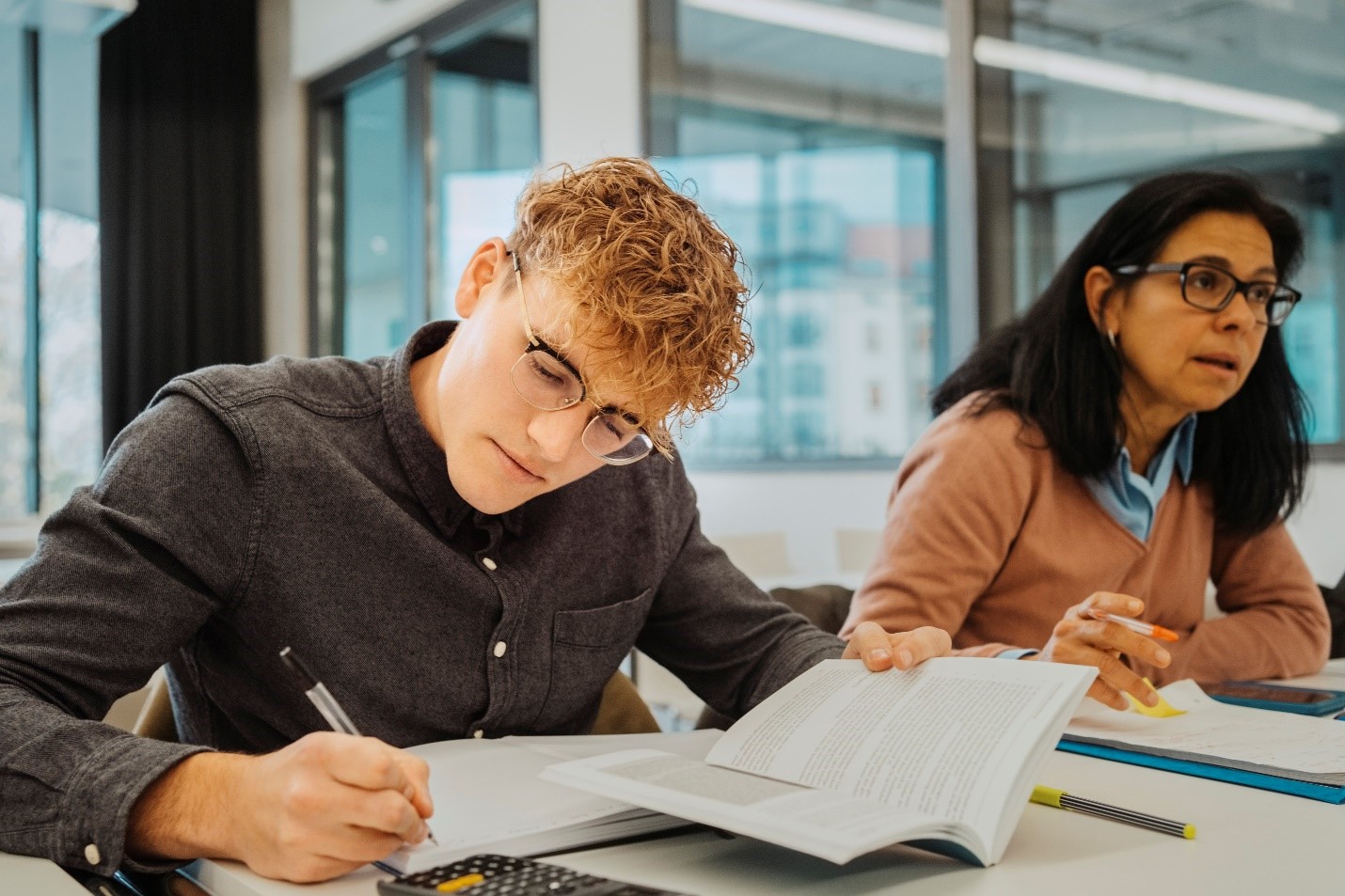 Male sitting at a table studying